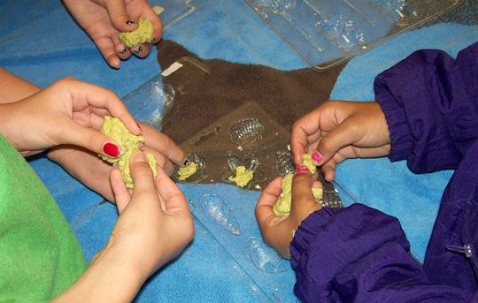 SWMD Bonnie Classroom Pics 012, 3 kid putting paper mache in plastic molds